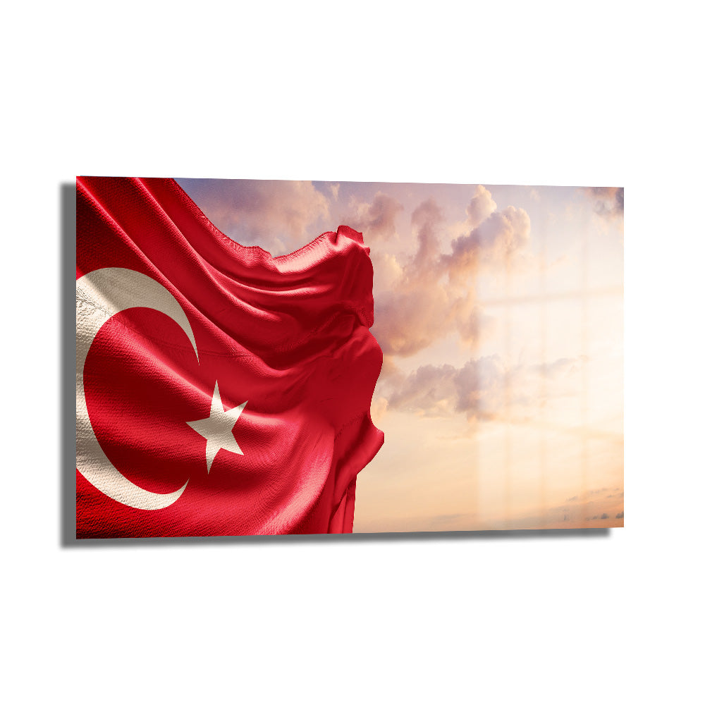 Rüzgarda dalgalanan Türk bayrağının gün batımı renkleriyle tasvir edildiği, Ay Yıldızlı Gurur: Dalgalanan Türk Bayrağı Dekoratif Cam Tablo.