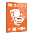 Turuncu arka planda, beyaz bir klozetin parıltılarla vurgulandığı ve "THE BEST SEAT IN THE HOUSE" yazısının yer aldığı, mizahi temalı bir cam tablo.