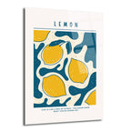 Beyaz zemin üzerinde büyük harflerle 'LEMON' yazan, altında sarı limon desenleri ve koyu mavi, krem renkli soyut şekillerle dolu modern bir cam tablo. Alt kısımda 'LIFE IS LIKE A BOX OF CITRUS - YOU NEVER KNOW WHAT YOU'RE GONNA GET' yazısı yer alıyor.