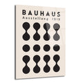 Açık krem rengi arka plan üzerinde siyah renkte 'BAUHAUS Ausstellung 1919' yazısı ve alt alta sıralanmış geometrik, minimalist şekillerden oluşan bir cam tablo. Şekiller arasında üstte ve altta 'dumbbell' benzeri formlar, ortada ise düz siyah daireler bulunmaktadır.