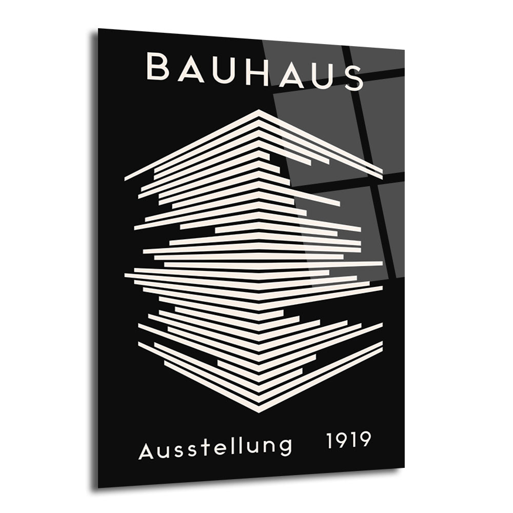 Siyah zemin üzerinde beyaz geometrik çizgilerle oluşturulmuş soyut bir bina tasarımını ve üstte 'BAUHAUS', altta 'Ausstellung 1919' yazısını içeren modern bir cam tablo.
