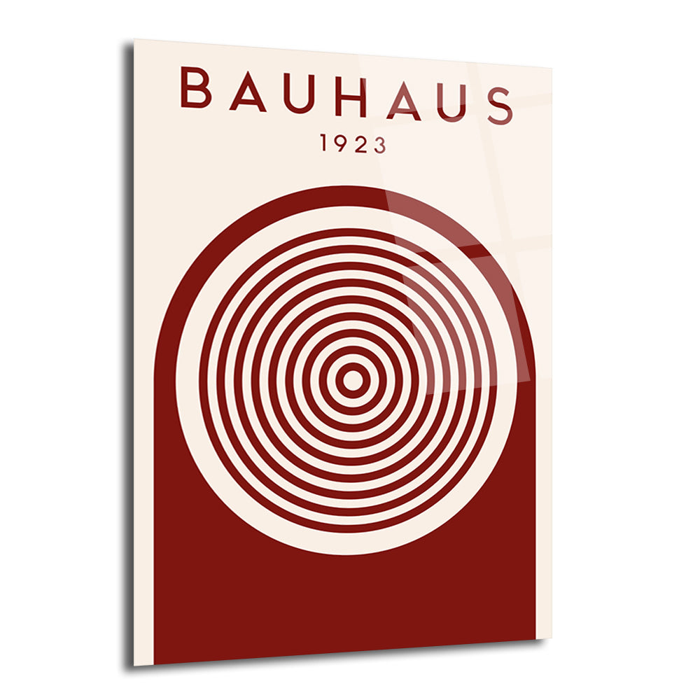 Krem rengi zeminde, üstte 'BAUHAUS 1923' yazısı ve altta kahverengi yarı daire içinde iç içe geçmiş dairelerden oluşan minimalist bir tasarım cam tablo.