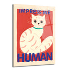 Kırmızı zemin üzerinde, huysuz bakışlı beyaz bir kedinin oturduğu ve üstünde 'IMPRESS ME' altında 'HUMAN' yazan mizahi cam tablo.