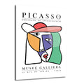 Beyaz zemin üzerinde, Picasso'nun kübist tarzında soyut bir insan yüzü portresi bulunan cam tablo. Yüz, turuncu, mor, yeşil, kırmızı ve pembe gibi canlı renklerle geometrik şekillerden oluşuyor. Üst kısımda 'PICASSO ORIGINAUX ET LITHOGRAPHIES' ve alt kısımda 'MUSEE GALLIERA PARIS' yazıları yer alıyor.