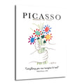 Beyaz zemin üzerinde, Picasso'nun "Barış Buketi" eserinden ilham alan, iki elin renkli ve stilize çiçeklerden oluşan bir buketi tuttuğu modern cam tablo. Üstte "PICASSO BOUQUET OF PEACE", altta "Everything you can imagine is real" yazısı yer alıyor.