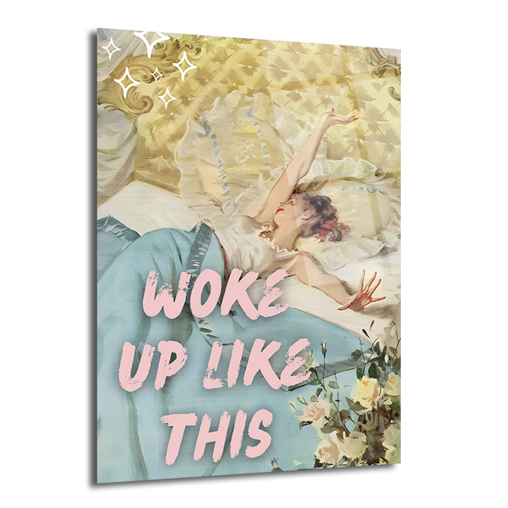 Vintage tarzda, yatakta uzanmış, yeni uyanmış gibi görünen, pastel mavi elbise giymiş bir kadının illüstrasyonu. Pembe büyük harflerle "WOKE UP LIKE THIS" yazısı ve etrafında parıltılar ile beyaz güller bulunuyor.